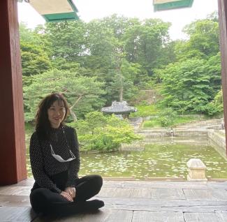 Tricia Park in front of a pond in Korea