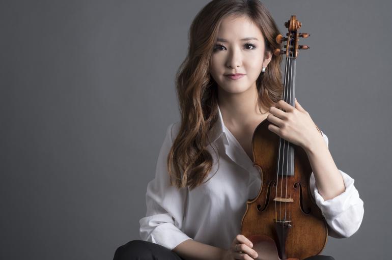 YooJin Jang sits holding a violin
