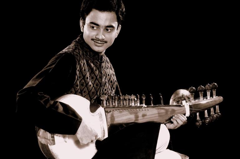A man playing the sarod