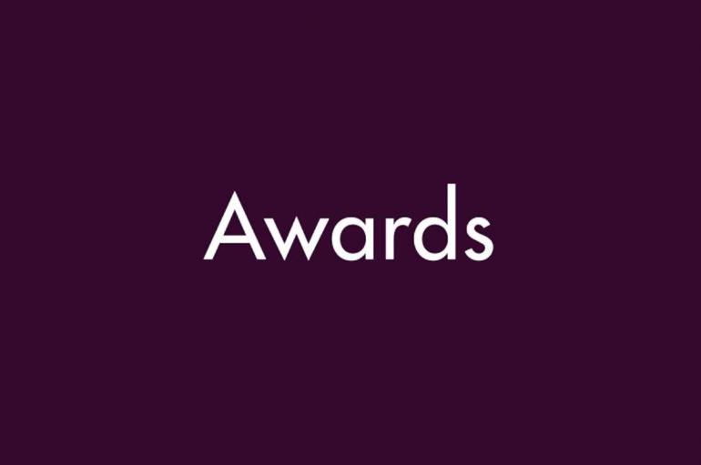 Purple background with white text that says "Awards"