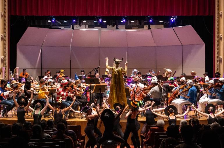 Orchestra on stage with conductors and dancers in costume