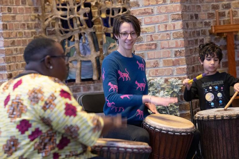 UChicago Assoc. Prof. Jennifer Iverson (center), director of the school’s Music Sociality program, participates in a drumming session with City Elementary students, led by autism advocate Victoria Boateng (left).