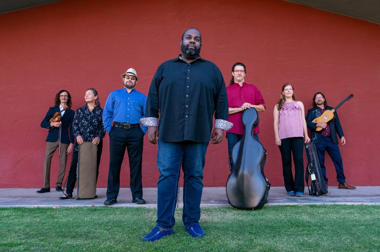 Music ensemble with seven members poses for a group picture
