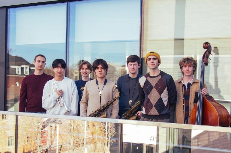 A group of musicians standing on a balcony