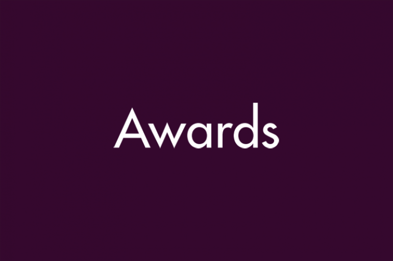 Dark purple background with white text that says "Awards"