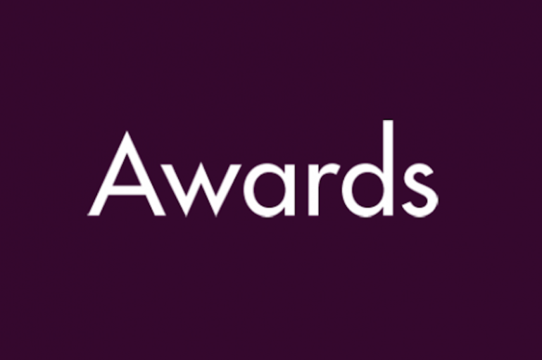 Dark purple background with white text that reads "Awards"