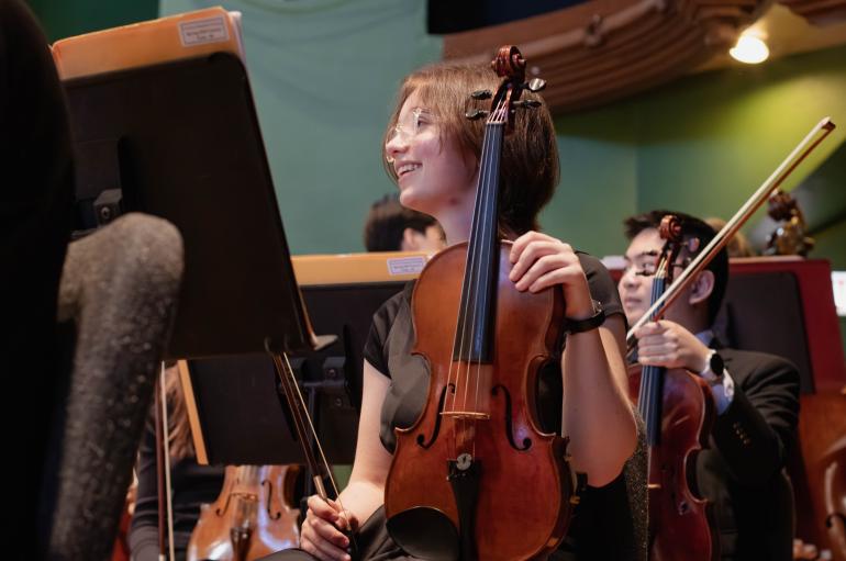 USO Member on stage with violin