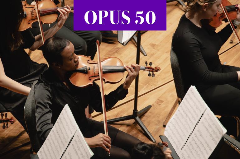USO Member on stage with violin