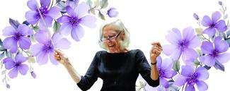 Barbara Schubert conducting with purple violets behind