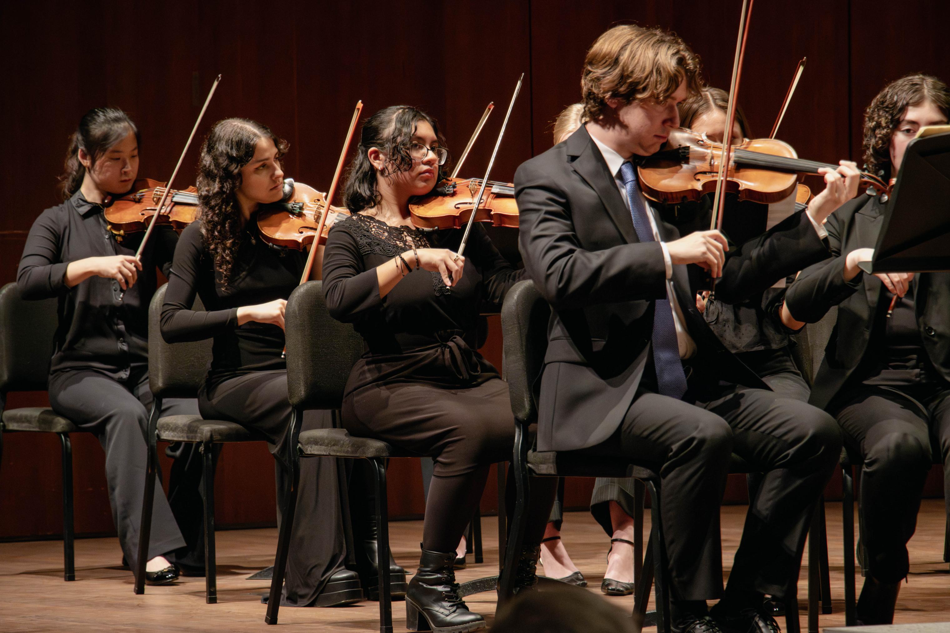 Members of University Chamber Orchestra performing in the Logan Center