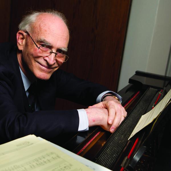 Philip Gossett sitting at a piano