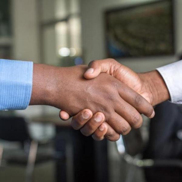 A close-up shot of the hands of two people shaking hands