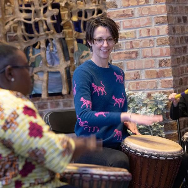 UChicago Assoc. Prof. Jennifer Iverson (center), director of the school’s Music Sociality program, participates in a drumming session with City Elementary students, led by autism advocate Victoria Boateng (left).