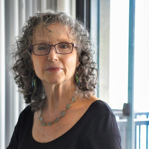 Headshot of Shulamit Ran, wearing a black shirt and seafoam green necklace.